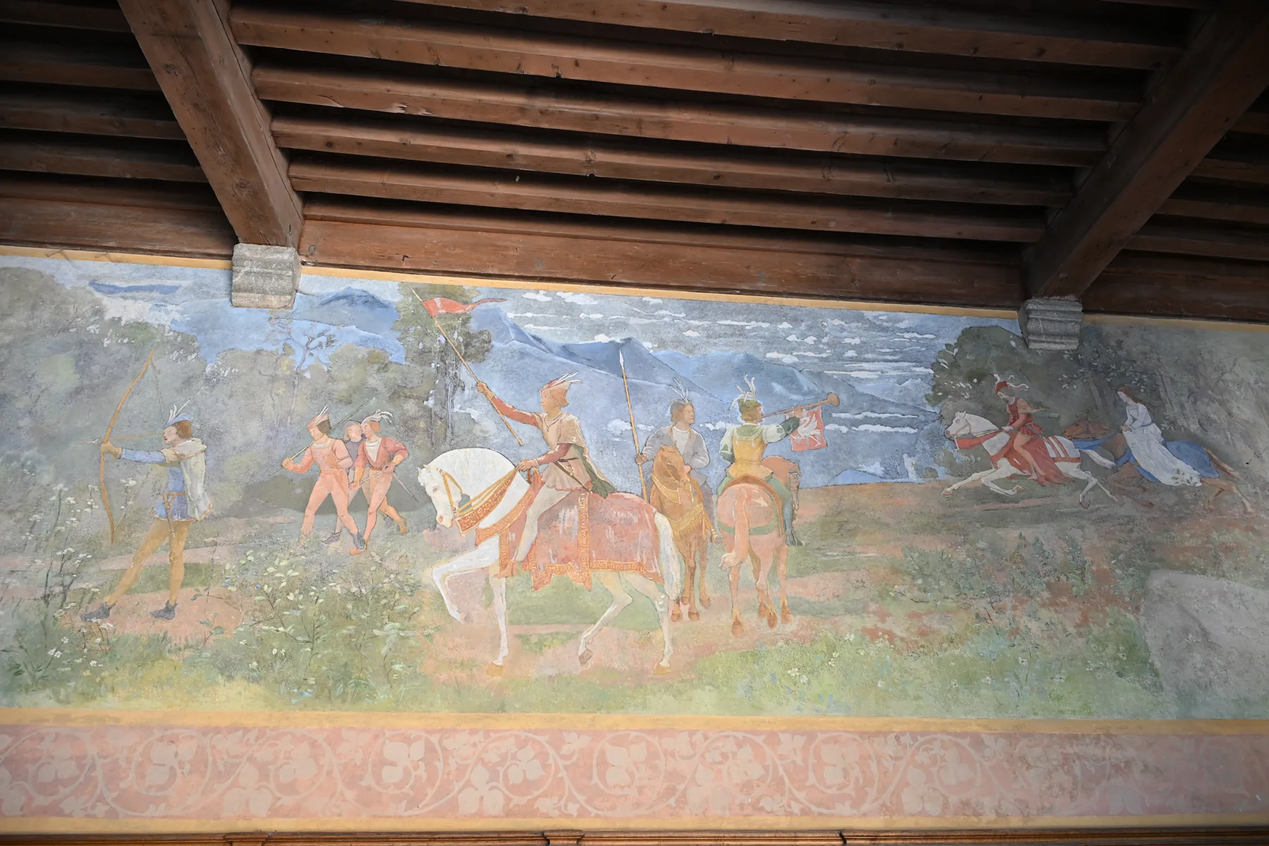Pintura mural com cavaleiros sob vigas de madeira no Castelo de Gruyères